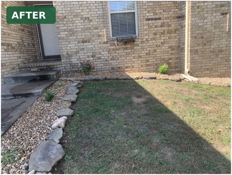 Side yard after work with a finished rock border
