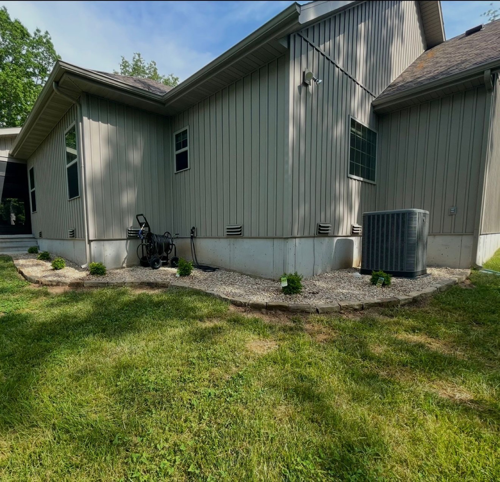 Rock beds and new plantings along a home's foundation