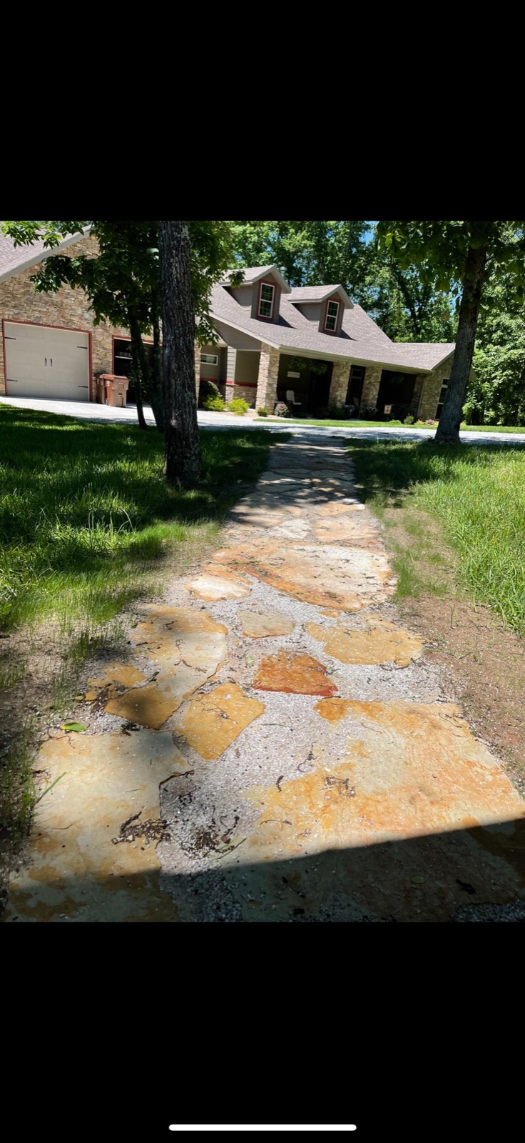 Natural flagstone walkway leading to a home