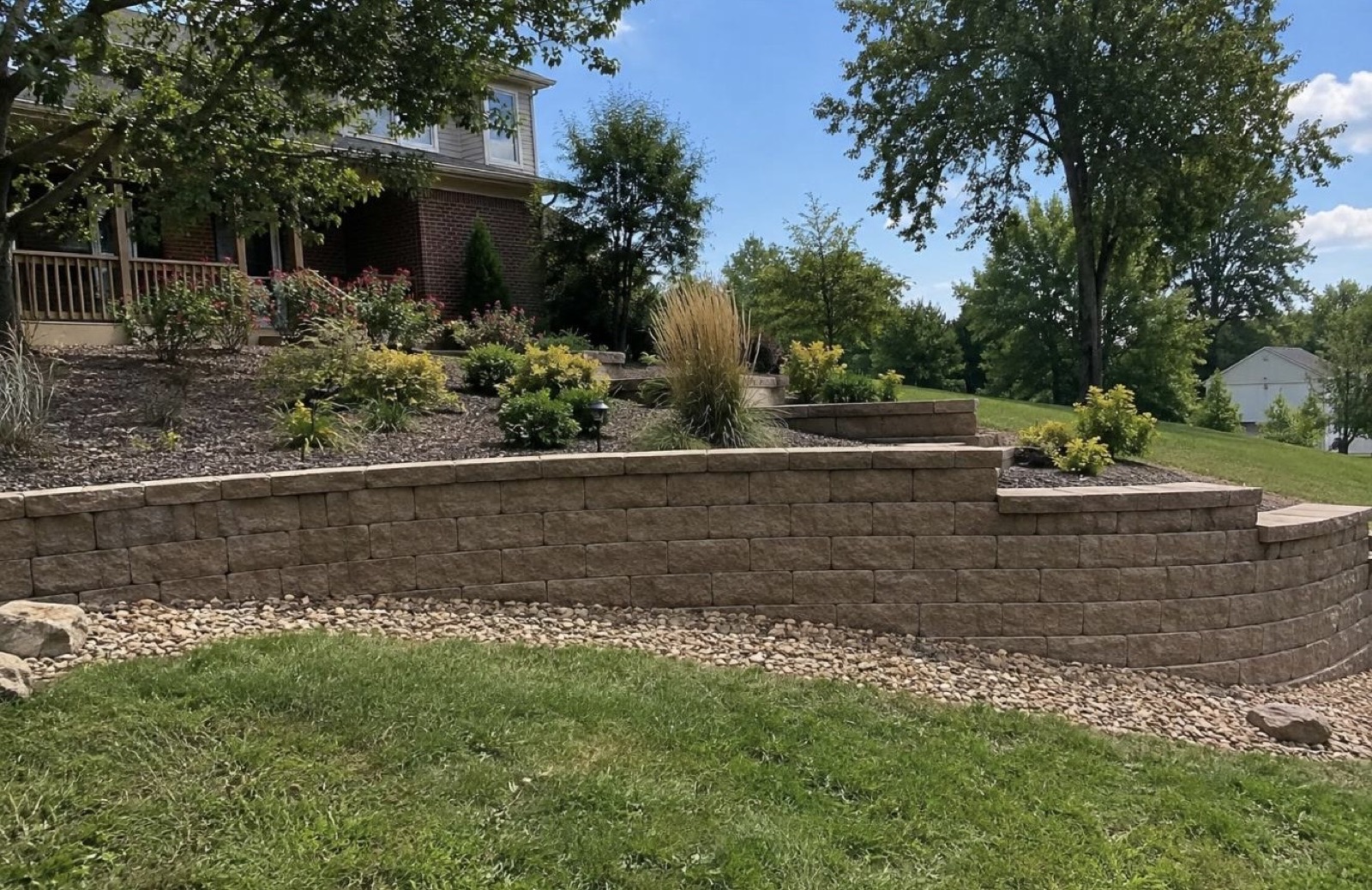 Curved block retaining wall with planted terrace above